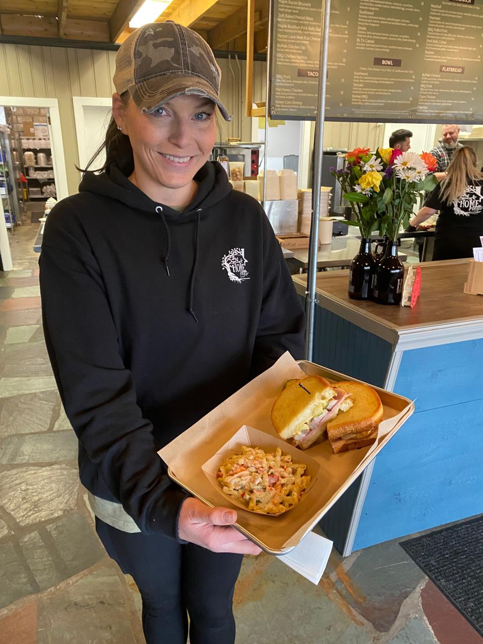 Ellen Trott, wife of owner Andy Trott, as well as co-owner, serving a pork belly cuban sandwich with homemade pasta salad on the side. Photo taken January 27, 2024 at lunchtime.