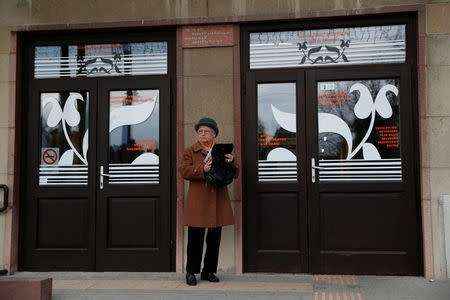 FILE PHOTO - A woman waits before a campaign forum of the right-wing Fidesz party in Ercsi, Hungary, March 9, 2018. REUTERS/Bernadett Szabo