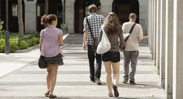 University students walking on campus, rear view