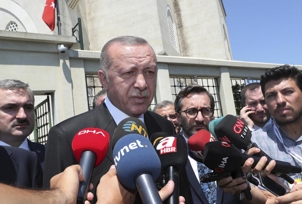 Turkey's President Recep Tayyip Erdogan speaks to the media after Friday prayers in Istanbul, Friday, July 5, 2019. A bomb went off in a car in Reyhanli, near Turkey's border with Syria on Friday, killing three Syrians who were inside the vehicle, Erdogan told reporters. The blast occurred some 750 meters (yards) from a local government office in Reyhanli in Hatay province, Turkey's state-run Anadolu Agency reported.(Presidential Press Service via AP, Pool)