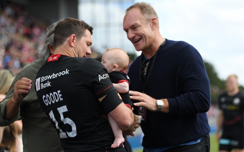 Alex Goode of Saracens introduces his baby to Francois Pienaar - GETTY IMAGES