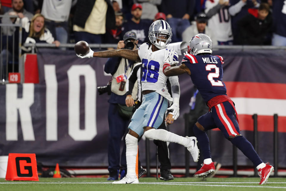 Dallas Cowboys wide receiver CeeDee Lamb (88) stretches the ball over the goal line for the game-winning touchdown, as New England Patriots cornerback Jalen Mills (2) gives chase, during overtime of an NFL football game, Sunday, Oct. 17, 2021, in Foxborough, Mass. (AP Photo/Michael Dwyer)