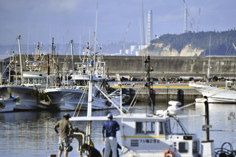 An exhaust stack of Fukushima Daiichi nuclear plant is seen from a fishing port in Namie, Fukushima prefecture, Japan Tuesday, Aug. 22, 2023. Japan will start releasing treated and diluted radioactive wastewater from the Fukushima Daiichi nuclear plant into the Pacific Ocean as early as Thursday, a controversial but essential early step in the decades of work to shut down the facility 12 years after its meltdown disaster. (Kyodo News via AP)