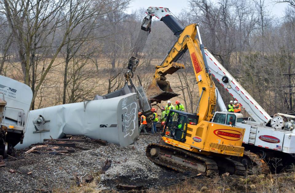 Crews remove rail cars away from the track Thursday after a train derailment Wednesday evening near Sharpsburg. The train was operated by Norfolk Southern.