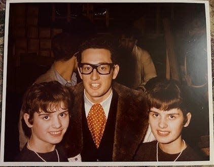 Buddy Holly posed with twins Joan, left, and Judy Bender for a photo taken by Larry Matti when the Winter Dance Party played the Riverside Ballroom in Green Bay on Feb. 1, 1959.