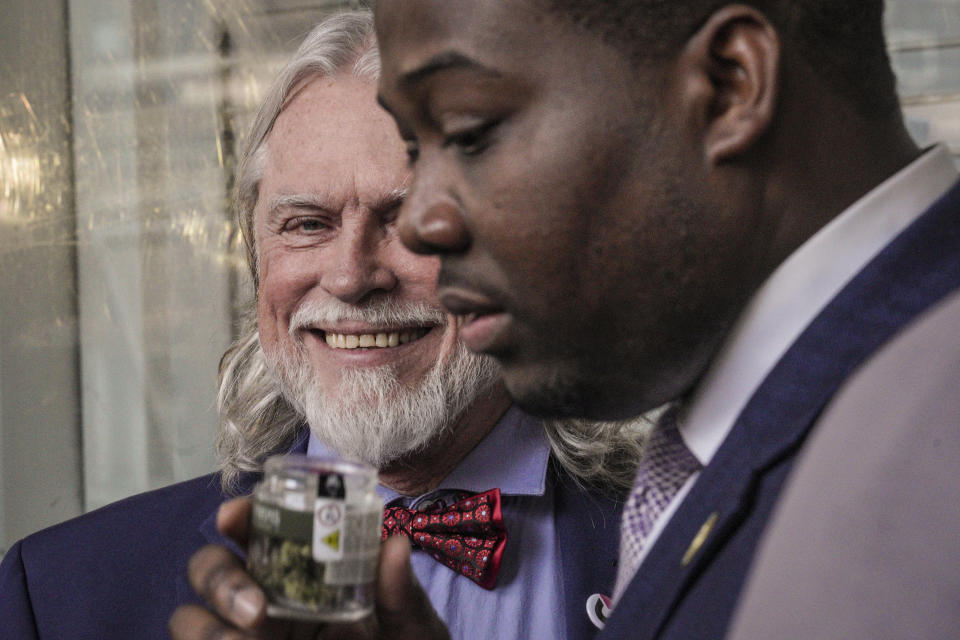 Charles King, left, CEO and founder of Housing Works, New York's first legal cannabis dispensary, smiles as Chris Alexander, right, executive director of New York State Office of Cannabis Management, takes a whiff of one of the first cannabis product made during the dispensary's kick-off press conference, Thursday Dec. 29, 2022, in New York. Housing Works, a minority-controlled nonprofit serving people with HIV and AIDS, as well as homeless and formerly incarcerated people, will be the first of 36 recently licensed dispensaries to begin selling cannabis to the general public. (AP Photo/Bebeto Matthews)