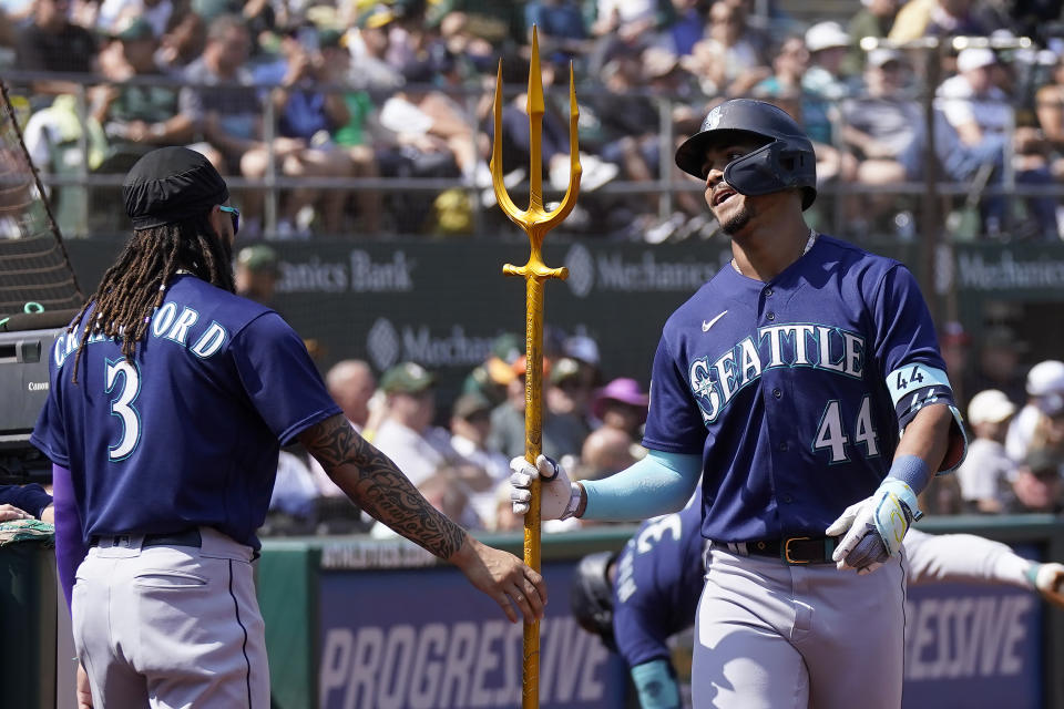 Seattle Mariners' Julio Rodriguez (44) is congratulated by J.P. Crawford (3) after hitting a home run against the Oakland Athletics during the fifth inning of a baseball game in Oakland, Calif., Wednesday, Sept. 20, 2023. (AP Photo/Jeff Chiu)