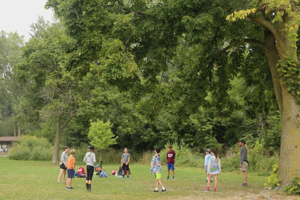 Kids play a game to kick start their day at the Pine Project's summer camp.