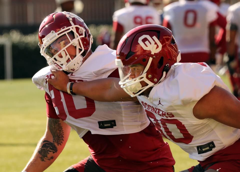 Trace Ford, right, pushes Rondell Bothroyd as the University of Oklahoma Sooners (OU) college football team holds spring practice outside of Gaylord Family/Oklahoma Memorial Stadium on March 21, 2023 in Norman, Okla.