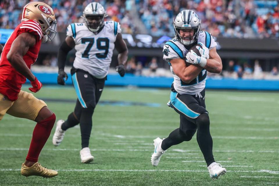 Panthers running back Christian McCaffrey protects the ball as he runs toward the end zone during the game against the 49ers at Bank of America Stadium on Sunday, October, 9, 2022.