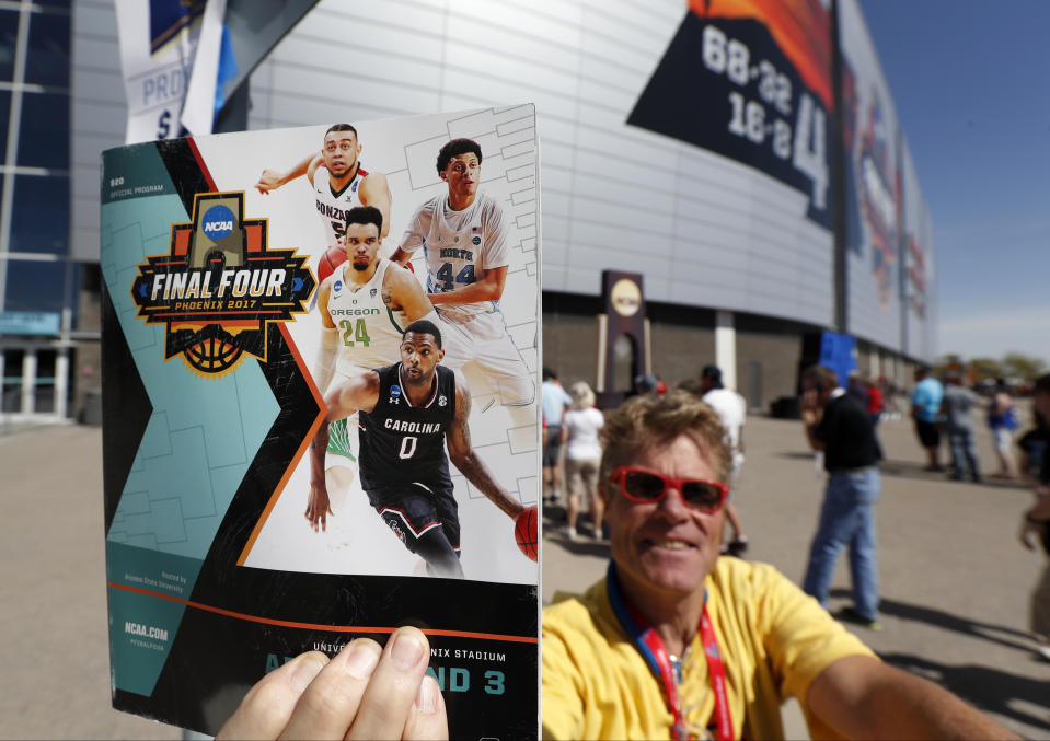 A vender displays a program outside University of Phoenix Stadium before the finals of the Final Four NCAA college basketball tournament between Gonzaga and North Carolina, Monday, April 3, 2017, in Glendale, Ariz. (AP Photo/Charlie Neibergall)