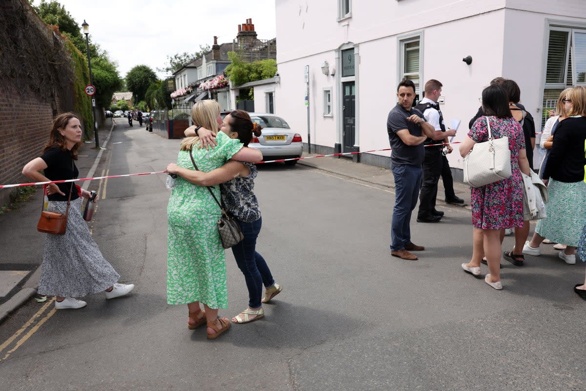People gather outside the cordon at the scene of the car crash at the Wimbledon school (Getty Images)