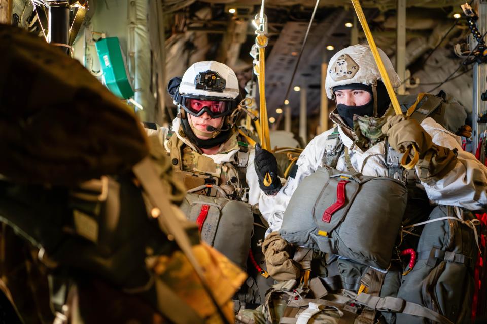 Paratroopers from the U.S. Army 2nd Infantry Brigade Combat Team (Airborne), 11th Airborne Division, hold onto static lines inside of a C-130J Super Hercules assigned to the 36th Airlift Squadron, Yokota Air Base, Japan, prior to conducting an airborne assault as part of a joint forcible entry exercise during Joint Pacific Multinational Readiness Center 24-02 in Alaska, Feb. 8, 2024.