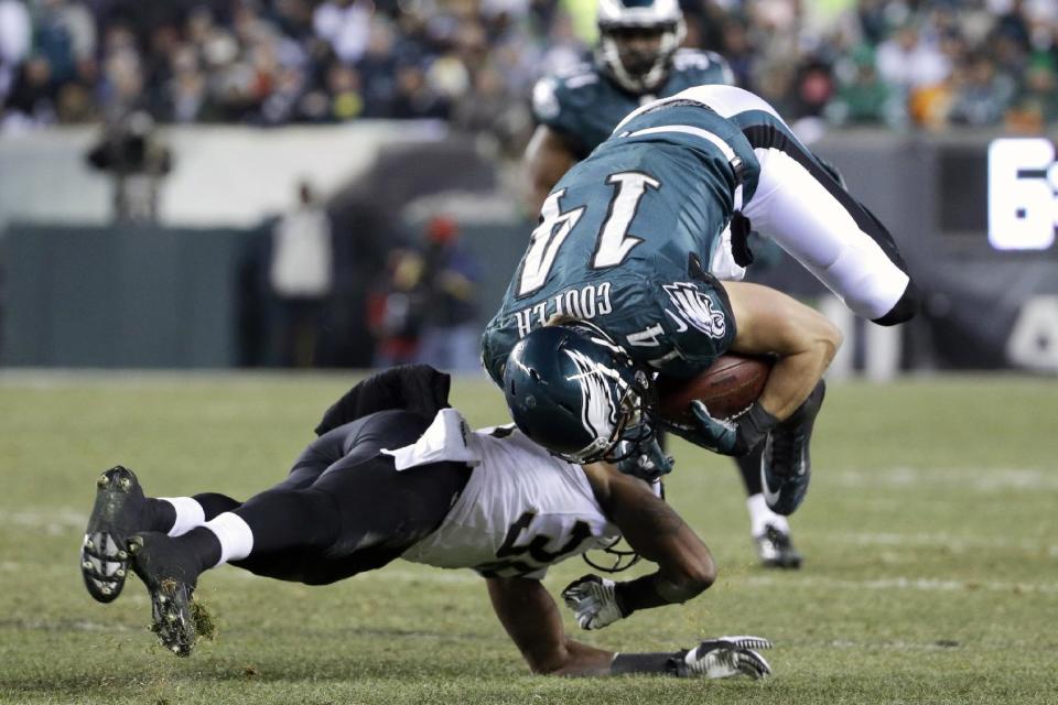Philadelphia Eagles' Riley Cooper, right, is upended on a hit by New Orleans Saints' Rod Sweeting during the second half of an NFL wild-card playoff football game, Saturday, Jan. 4, 2014, in Philadelphia. (AP Photo/Matt Rourke)