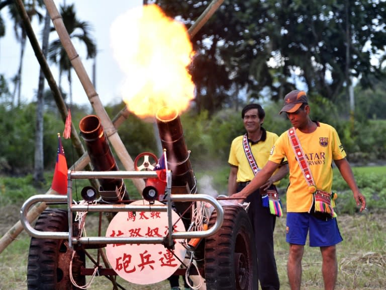 Members of the Amis indigenous group fire a locally-made bamboo cannons in a salute to their tribe during the traditional harvest festival in Hualien, eastern Taiwan