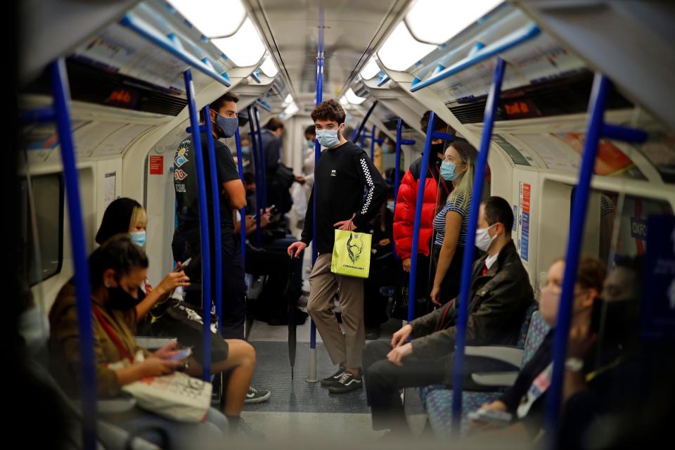 Commuters wearing protective face coverings travel on Victoria line at rush hour in central London on September 23, 2020. - Britain on Tuesday tightened restrictions to stem a surge of coronavirus cases, ordering pubs to close early and advising people to go back to working from home to prevent a second national lockdown. (Photo by Tolga Akmen / AFP) (Photo by TOLGA AKMEN/AFP via Getty Images)