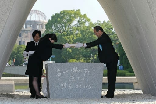 Hiroshima Mayor Kazumi Matsui offers a new list of A-bomb dead, including individuals who died in the past year from the side effects of radiation, at the memorial service