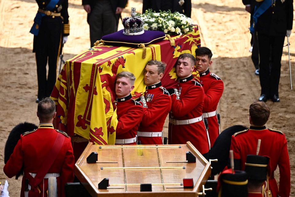 Pallbearers from The Queen's Company, 1st Battalion Grenadier Guards carry the coffin of Queen Elizabeth II into Westminster Hall at the Palace of Westminster