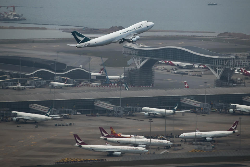 A Cathay Pacific Airways aircraft takes off at the Hong Kong International Airport on March 6, 2020. Hong Kong airline Cathay Pacific Airways on Wednesday, Oct. 21, 2020, said it would cut 8,500 jobs and shut down its regional airline unit in a corporate restructuring, as it grapples with the plunge in air travel due to the pandemic. (AP Photo/Kin Cheung)