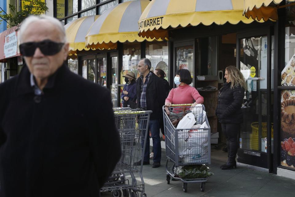 Customers of Elat Market in Pico-Robertson watch Friday as LAPD officers pass by on horseback