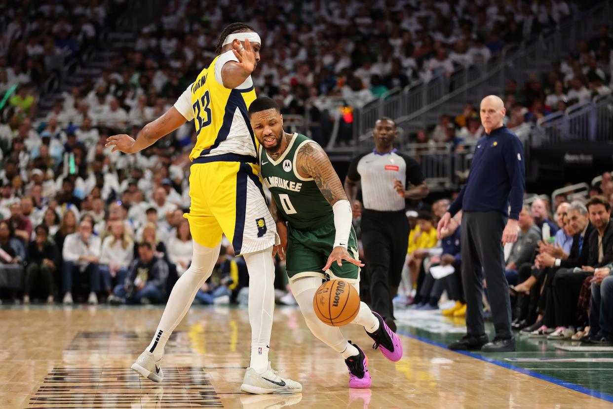 MILWAUKEE, WISCONSIN - APRIL 23: Damian Lillard #0 of the Milwaukee Bucks drives around Myles Turner #33 of the Indiana Pacers during the second half of game two of the Eastern Conference First Round Playoffs at Fiserv Forum on April 23, 2024 in Milwaukee, Wisconsin. NOTE TO USER: User expressly acknowledges and agrees that, by downloading and or using this photograph, User is consenting to the terms and conditions of the Getty Images License Agreement. (Photo by Stacy Revere/Getty Images)