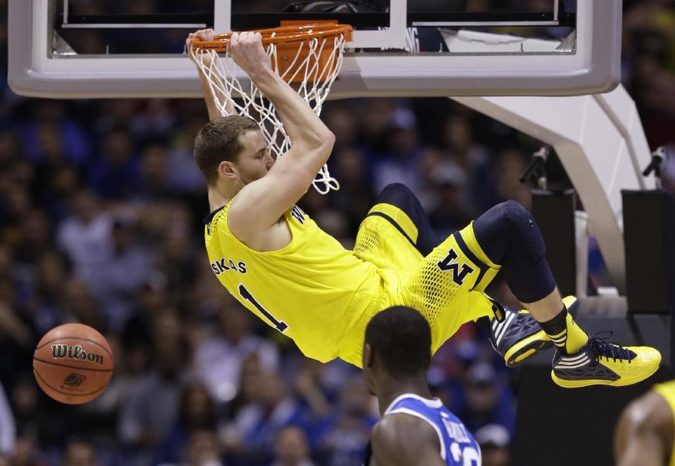 Michigan's Nik Stauskas dunks during the second half of an NCAA Midwest Regional final college basketball tournament game against Kentucky Sunday, March 30, 2014, in Indianapolis. (AP Photo/David J. Phillip)