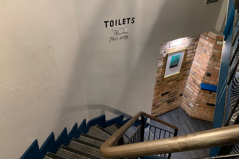 The photo shows the stairs up to the toilets