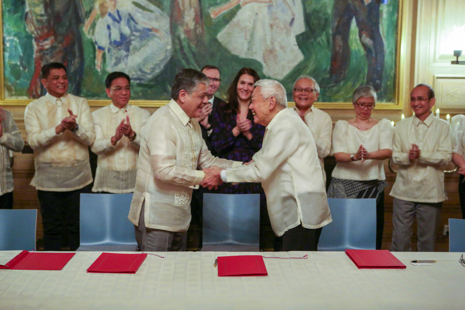 Special Adviser to the President, Minister Antonio Lagdameo, center, and Luis Jalandoni of the Communist Movement (NDFP) shake hands after signing their joint vision for peace, at Oslo City Hall, on Thursday, Nov. 23, 2023. The Philippine government and the country’s communist rebels have agreed to resume talks aimed at ending decades of armed conflict, one of Asia's longest, Norwegian mediators announced Tuesday, Nov. 28, 2023. High-ranking delegations from both sides met in the Norwegian capital last week and agreed to a “common vision for peace” that sought to address key obstacles, according to Norway’s foreign ministry. (Mathias Rongved/Norwegian Ministry of Foreign Affairs via NTB)