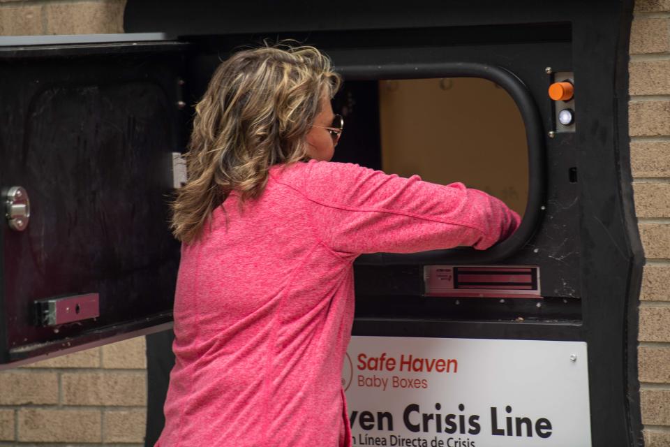 Safe Haven founder Monica Kelsey puts in a baby doll to showcase how the dropoff box works during the unveiling of the Safe Haven Baby Box at Jackson Fire Department Station 2 in Jackson, Tenn. on Sept. 13, 2023.