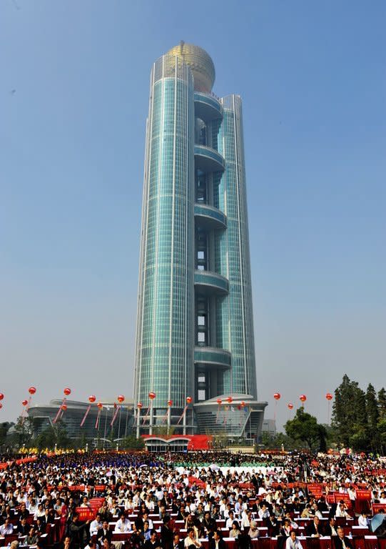 This file photo shows guests attending the opening ceremony of the Longxi International Hotel, standing at 328 m high, that cost $470 mln to build, in Huaxi, which is still classed as a village in east China's Jiangsu province, on October 8, 2011. One of China's tallest buildings opened for business in the nation's 'wealthiest village,' a symbol of the country's breakneck economic growth