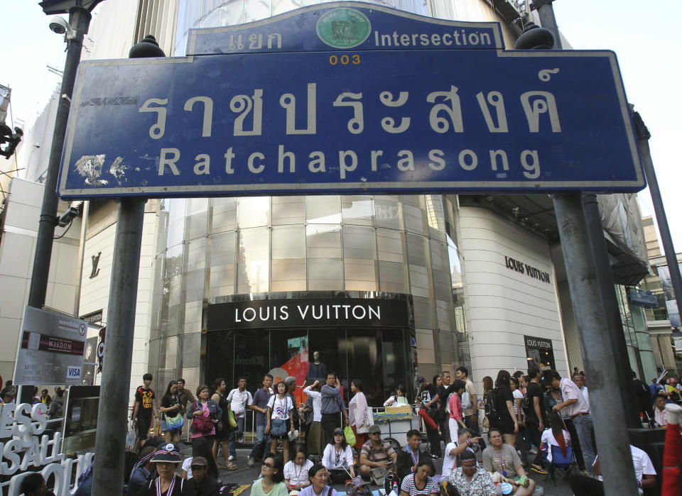 In this photo taken Jan. 15, 2014, anti-government protesters gather during a rally led by former deputy prime minister Suthep Thaugsuban at Ratchabrasong intersection in Bangkok, Thailand. Four years ago Suthep ordered a crackdown that saw the army rip through anti-government protesters’ tire-and-bamboo-barricaded encampments and fire M-16s into crowds of fleeing protesters. Today, he is leading a protest movement that has itself blocked roads and broken into government offices - an extraordinary role reversal that underscores not only the cyclical nature of Thai politics, but the total lack of progress toward bridging a political divide that has plagued the country for nearly a decade. Among the places his supporters occupy is the place the Red Shirts made their last stand four years ago: Ratchaprasong, the country’s glitziest intersection, where just like the Red Shirts, protesters are camping in the middle of the road, in front of a huge stage complete with speakers and a giant video screen. (AP Photo/Sakchai Lalit)