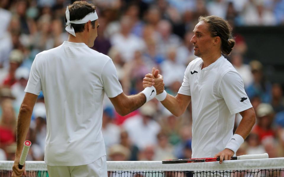 Alexandr Dolgopolov concedes defeat to Roger Federer after retiring from the fray - REUTERS