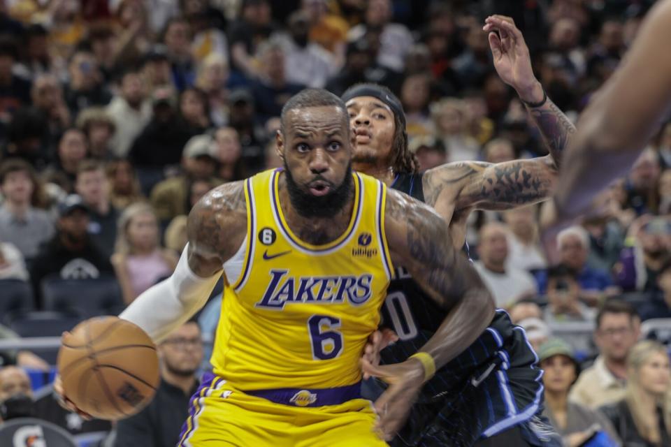 Los Angeles Lakers forward LeBron James drives past Orlando Magic guard Markelle Fultz