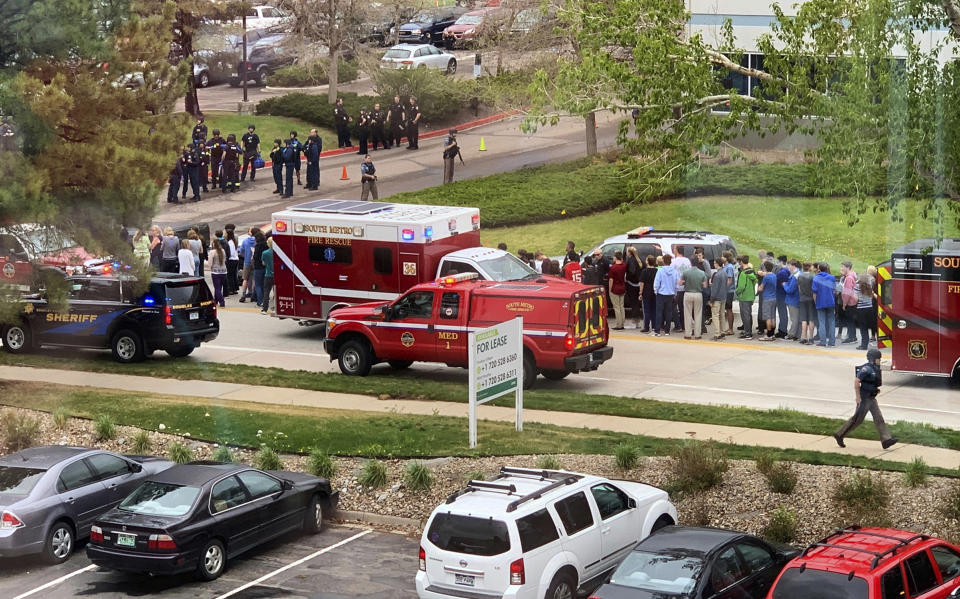 FILE - In this May 7, 2019 file photo, police and students are seen outside STEM School Highlands Ranch, a charter middle school in the Denver suburb of Highlands Ranch, Colo., after a shooting. The younger of two students charged in a school shooting in suburban Denver that killed a classmate has pleaded guilty. Prosecutors say 16-year-old Alec McKinney pleaded guilty on Friday, Feb. 7, 2020 to 17 felonies, including a first-degree murder charge. In December, a judge ruled that McKinney would be prosecuted as an adult in the May 7 shooting at STEM School Highlands Ranch that killed 18-year-old Kendrick Castillo. Devon Erickson has pleaded not guilty to the same charges McKinney faced in the shooting. (Courtney Harper via AP, File)