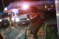 A soldier guards the entrance of an immigration detention center where a deadly fire broke out in Ciudad Juarez, Mexico, Tuesday, March 28, 2023. (AP Photo/Christian Chavez)