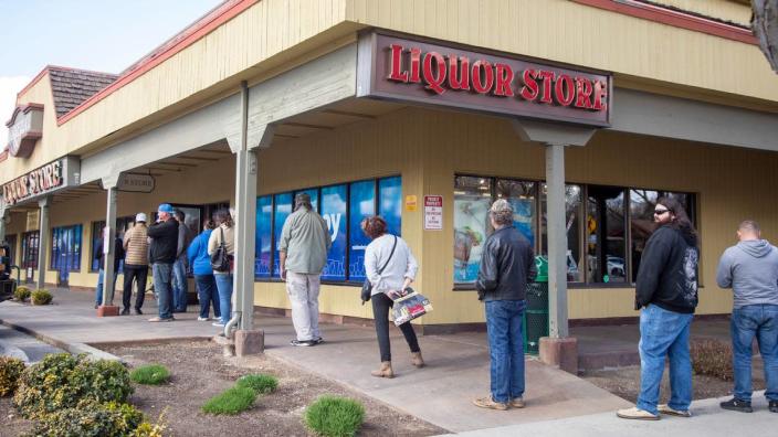 In 2020, customers lined the sidewalk in front of the state liquor store at 17th and State streets after Gov. Brad Little ordered Idahoans to stay at home except for essential business.