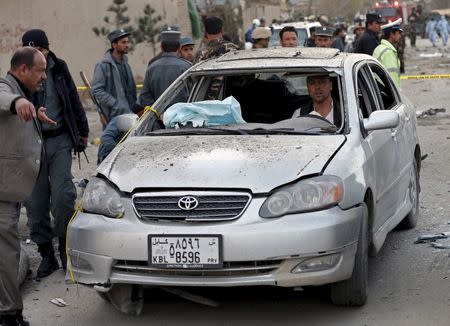 An Afghan man drives his damaged car away from site of a suicide attack in Kabul March 25, 2015. REUTERS/Mohammad Ismail