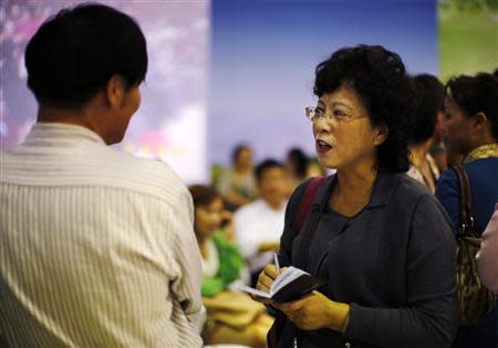 A man and a woman chat during a matchmaking event for middle-aged singles and seniors, sponsored by Shanghai's government, in Shanghai November 9, 2013. REUTERS/Carlos Barria