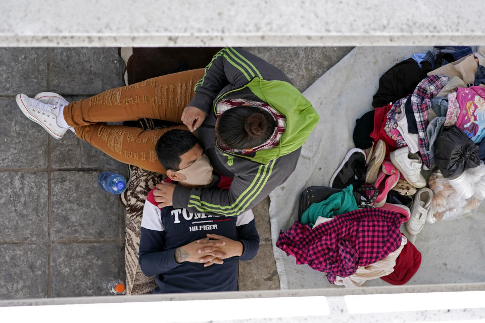 Migrants who were caught trying to cross into the U.S. and were deported rest under a ramp that leads to the McAllen-Hidalgo International Bridge on Thursday, March 18, 2021, in Reynosa, Mexico. (AP Photo/Julio Cortez)