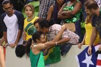 <p>Iziane Castro of Brazil is comforted by her mother after defeat during the Women’s round Group A basketball match between Brazil and Turkey on Day 7 of the Rio 2016 Olympic Games at the Youth Arena in Rio de Janeiro on August 13, 2016 in Rio de Janeiro, Brazil. (Photo by Mark Kolbe/Getty Images) </p>