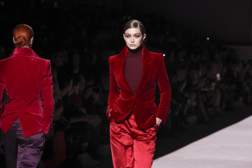 <p>Many young designers are paying homage to the '90s recently: there's been a resurgence of sharp suiting, animal prints, bike shorts, square neck tops, velvet, bodysuits, and even low-rise denim. They are, in many ways, paying homage to Tom Ford's decade-defining fashion while he was at the helm of Gucci. </p><p>Perhaps as a reminder of where it all started, Tom Ford's fall 2019 collection nodded to his own 1996 collection for Gucci. The collection was predominantly combinations of suiting-dress shirts, pleat-front pants, blazers-done in shiny silks and sumptuous velvets. The fit, aside from the nipped-in blazers, was louche and dripping with signature Tom Ford sex appeal. There was even a red velvet blazer paired with red silk pants, modeled by Gigi Hadid, that seemed to be a direct throwback to the red velvet suit from his 1996 Gucci collection, memorably worn by Gwyneth Paltrow at the MTV music awards. </p><p>The slinky evening wear section also nodded to ‘96 Gucci: elegant columns in a stretch material with cut outs, updated for 2019 with heavy chain link details and capes that gathered around the arms like a shirt as you’re slipping it off and over your head. <br></p>