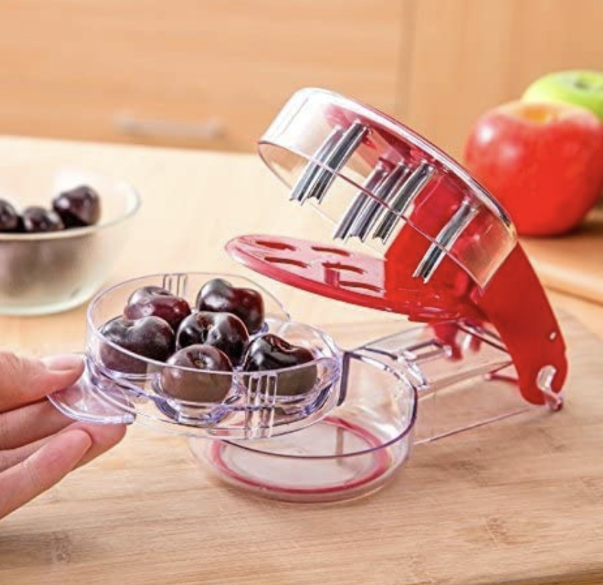 someone using a cherry pitter