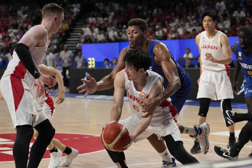 Japan guard Makoto Hiejima (6), front, and Cape Verde center Edy Tavares (22) fight for a loose ball in the second half of their Basketball World Cup classification match in Okinawa, southern Japan, Saturday, Sept. 2, 2023. (AP Photo/Hiro Komae)