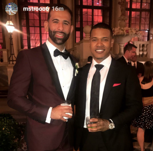 <p>Marcus Stroman and Jose Bautista flash matching smiles at the reception. (Instagram – @mstrooo6) </p>