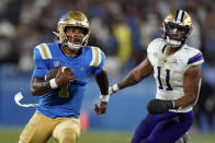 UCLA quarterback Dorian Thompson-Robinson (1) runs past Washington linebacker Alphonzo Tuputala (11) during the first half of an NCAA college football game Friday, Sept. 30, 2022, in Pasadena, Calif. (AP Photo/Marcio Jose Sanchez)