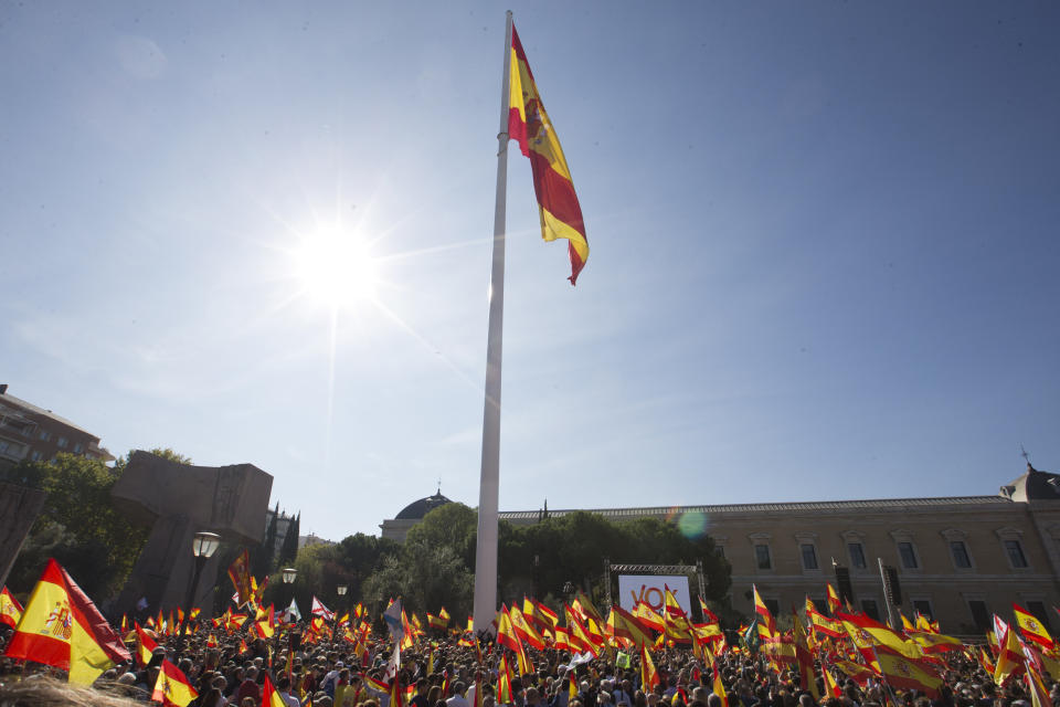 A big Spanish flag flutters as other wave smaller Spanish flags during for a rally to promote 'Spanish Unity' during a rally by the right wing VOX party in Madrid, Spain, Saturday, Oct. 26, 2019. The VOX rally comes 2 days after the exhumation and reburial of Spanish dictator Gen. Francisco Franco from the grandiose Valley of the Fallen mausoleum outside Madrid to their new resting place at the Mingorrubio cemetery, 57 kilometers (35 miles) away. (AP Photo/Paul White)