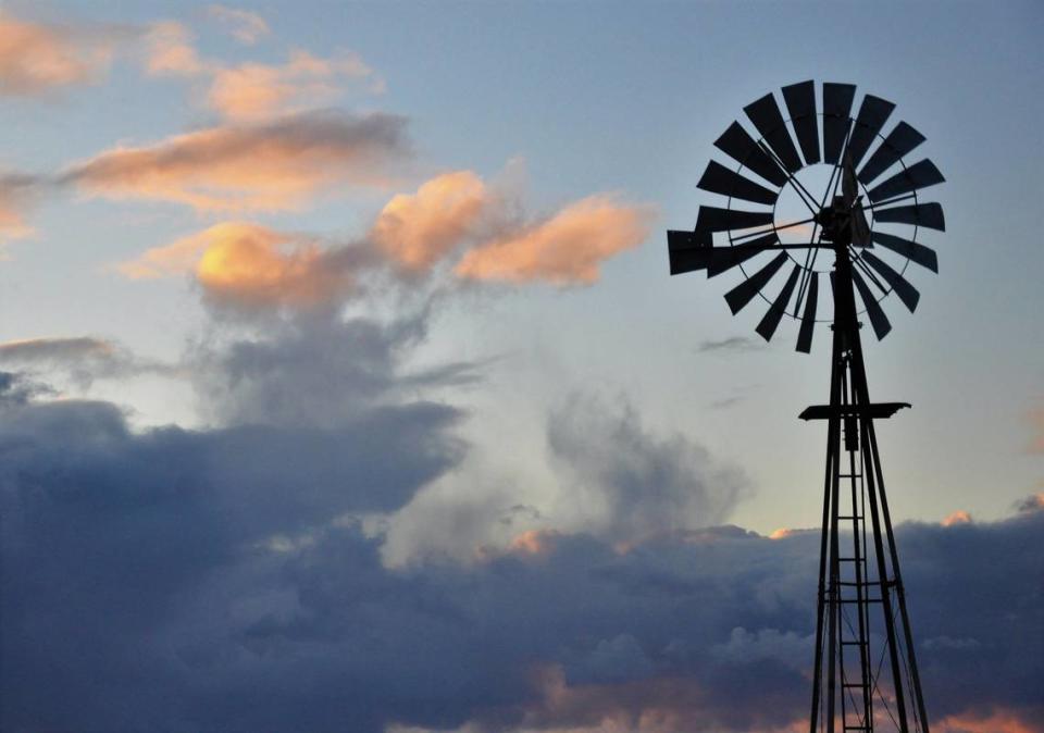 A still windmill stands before a cloud bank on Turri Road near Los Osos.