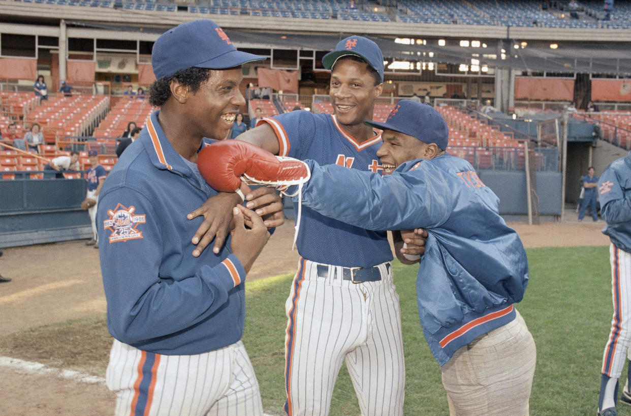 Heavyweight contender Mike Tyson, right, jokes with New York Mets players Dwight Gooden, left, and Darryl Strawberry as they clown for the cameras before a game with the Montreal Expos on Sept. 10, 1986, at Shea Stadium. (AP Photo/Ray Stubblebine)