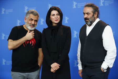 Diector, screenwriter and producer Mani Haghighi with actors Leila Hatami and Hasan Majuni pose during a photocall to promote the movie Khook (Pig) at the 68th Berlinale International Film Festival in Berlin, Germany, February 21, 2018. REUTERS/Hannibal Hanschke