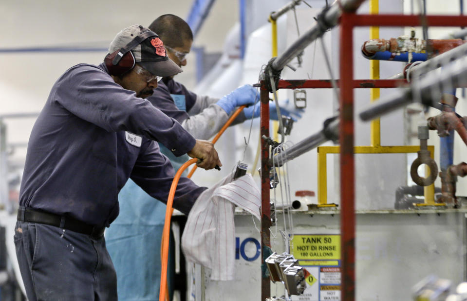 FILE - In this Thursday, Oct. 10, 2013, file photo, employees at Sheffield Platers Inc. work on the factory floor in San Diego. The Commerce Department releases fourth-quarter gross domestic product on Thursday, Jan. 30, 2014 (AP Photo/Lenny Ignelzi, File)